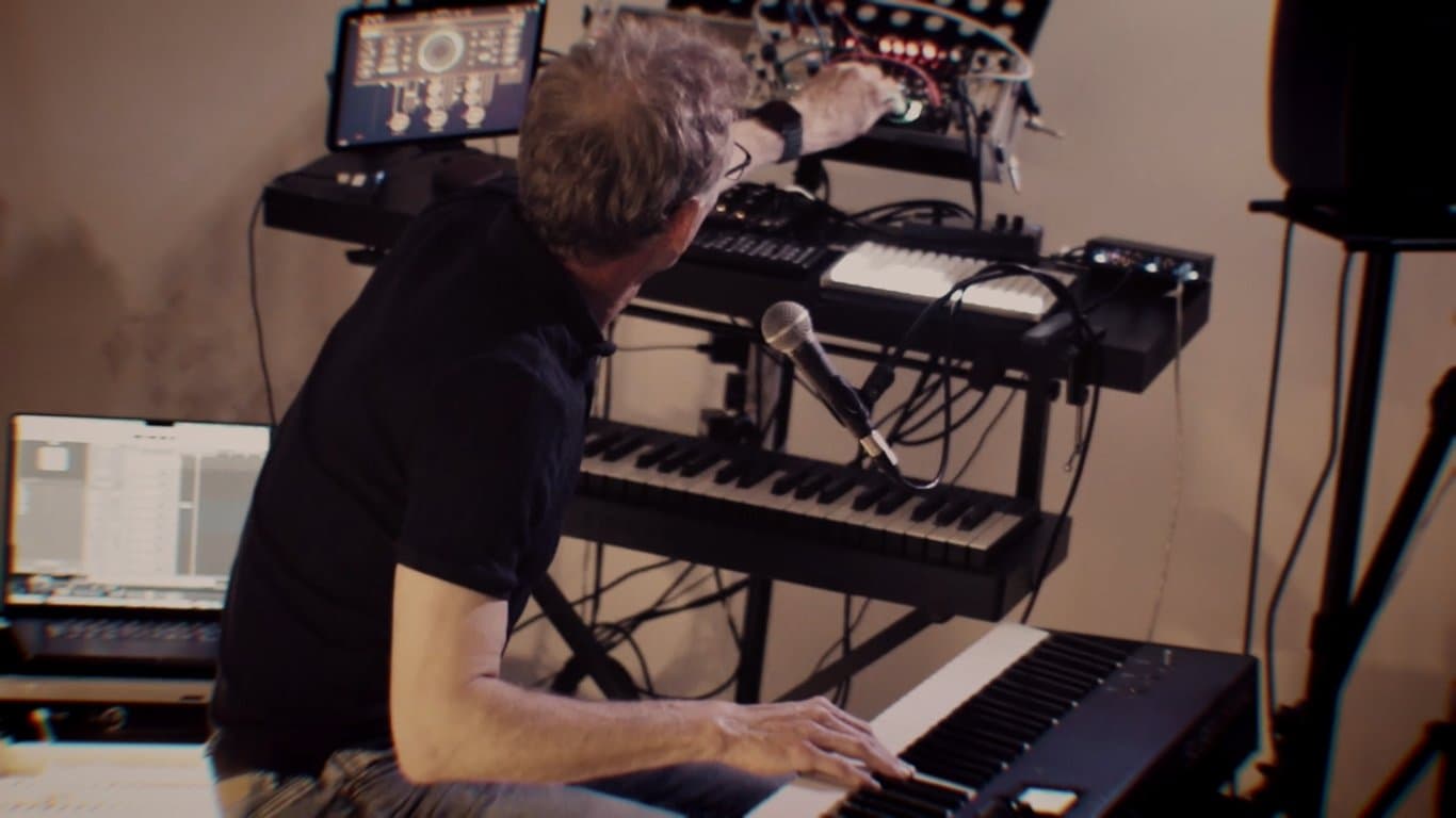 Giles Lamb at his Unstable Systems rig during the 8 June 2026 live performance, hands on the keyboard controlling synths mid-improvisation